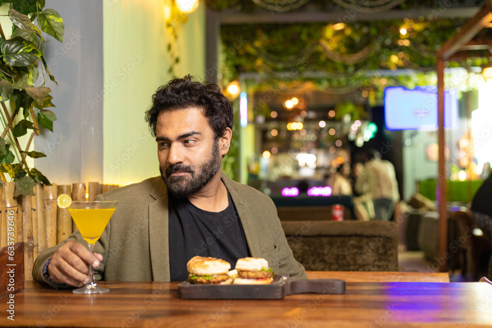 Indian man enjoying fast food at restaurant Indian man enjoying fast food at restaurant