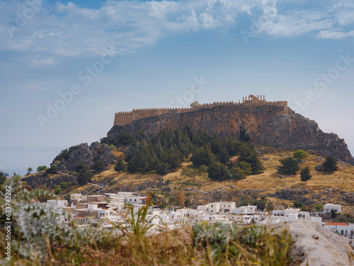 Lindos town in Greece aerial view in cloud summer day, white houses in Rhodes island , cityscape viewpoint traditional greek architecture, famous landmark and touristic destination concept