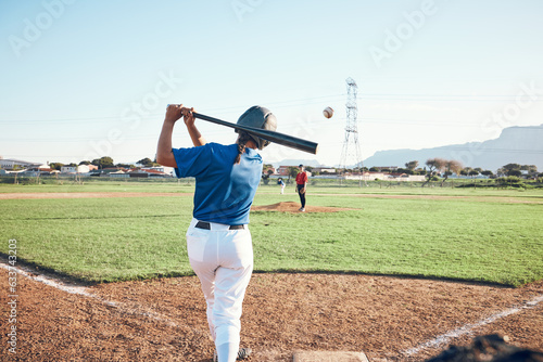 Baseball, bat and person swing at ball outdoor on a pitch for sports, performance and competition. Behind athlete or softball player ready for game, training or exercise challenge at field or stadium