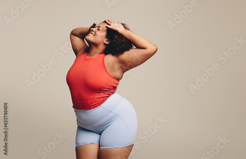 Expressive dance workout: Curvy woman enjoying moving her body photo