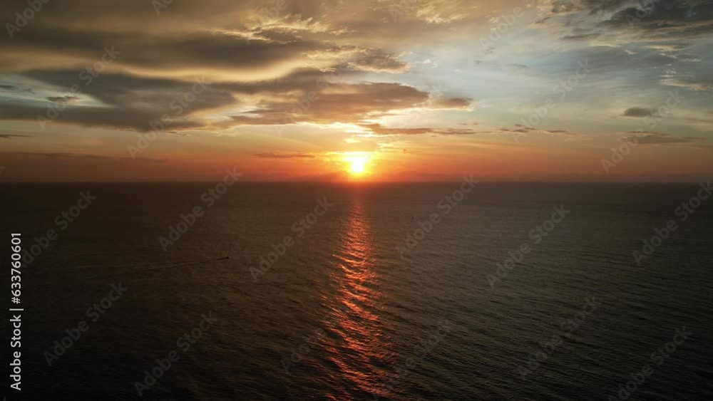 Aerial view over beautiful ocean during sunset evening. Top view to the ocean in summer day while sunset - closeup. Drone view of a Scenic slow motion ocean waves. Beautiful sundown over the ocean. Aerial view over beautiful ocean during sunset evening. Top view to the ocean in summer day while sunset - closeup. Drone view of a Scenic slow motion ocean waves. Beautiful sundown over the ocean.