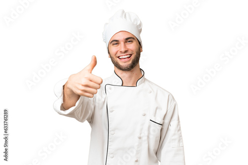 Young handsome chef man over isolated background with thumbs up because something good has happened