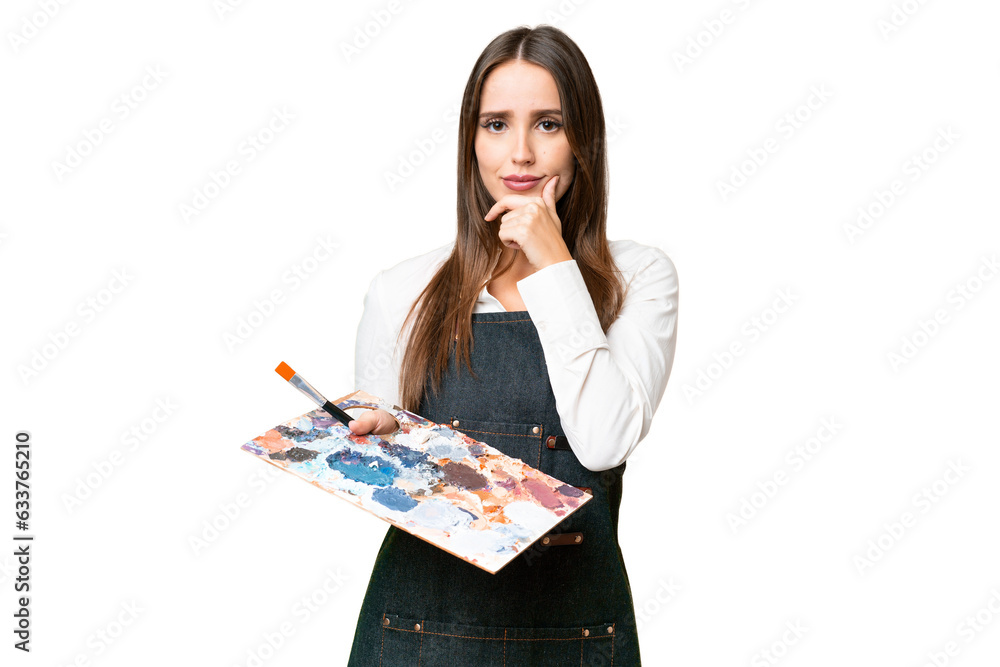 Young artist woman holding a palette over isolated chroma key background thinking Young artist woman holding a palette over isolated chroma key background thinking