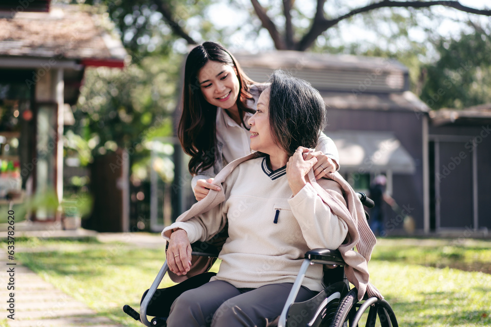 Senior on wheelchair and daughter family concept, Young asian woman blanket disabled mother on wheelchair