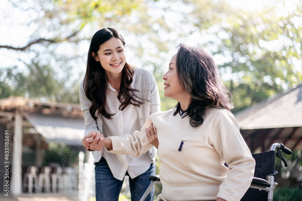 Senior on wheelchair and daughter family concept, Young asian woman helping disabled mother to get up Senior on wheelchair and daughter family concept, Young asian woman helping disabled mother to get up