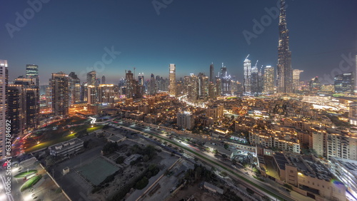 Dubai Downtown day to night transition with tallest skyscraper and other towers