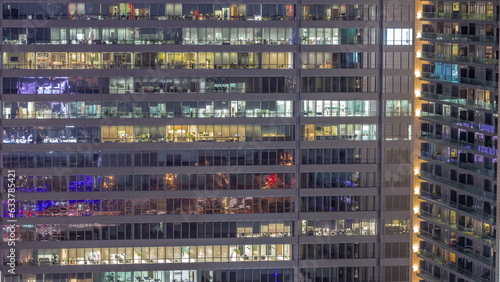 Windows of office buildings day to night timelapse, the light from the windows of houses