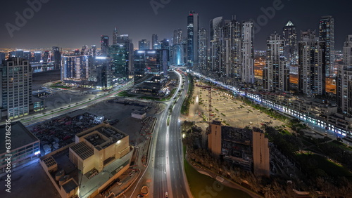 Panorama showing Bay Avenue with modern towers residential development in Business Bay aerial night timelapse, Dubai © neiezhmakov