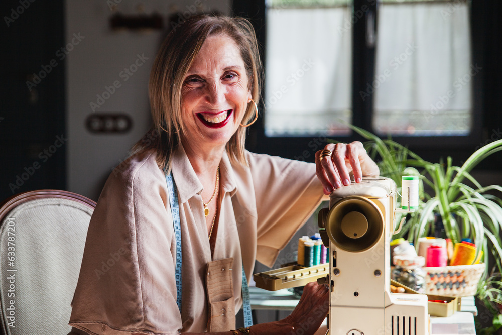 happy seamstress with her sewing machine happy seamstress with her sewing machine