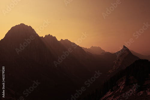 An ominous red-skied landscape with views of mountains 