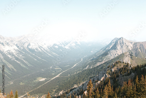 Views of mountains, forests and a major highway on a summers day in Kananaskis Country, Alberta, Canada from on top of King Creek Ridge