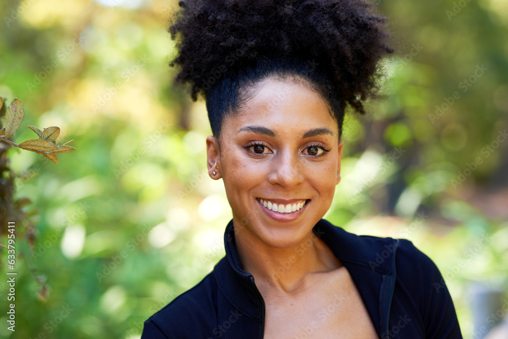 Portrait of beautiful multi-ethnic woman with curly afro standing in park Portrait of beautiful multi-ethnic woman with curly afro standing in park