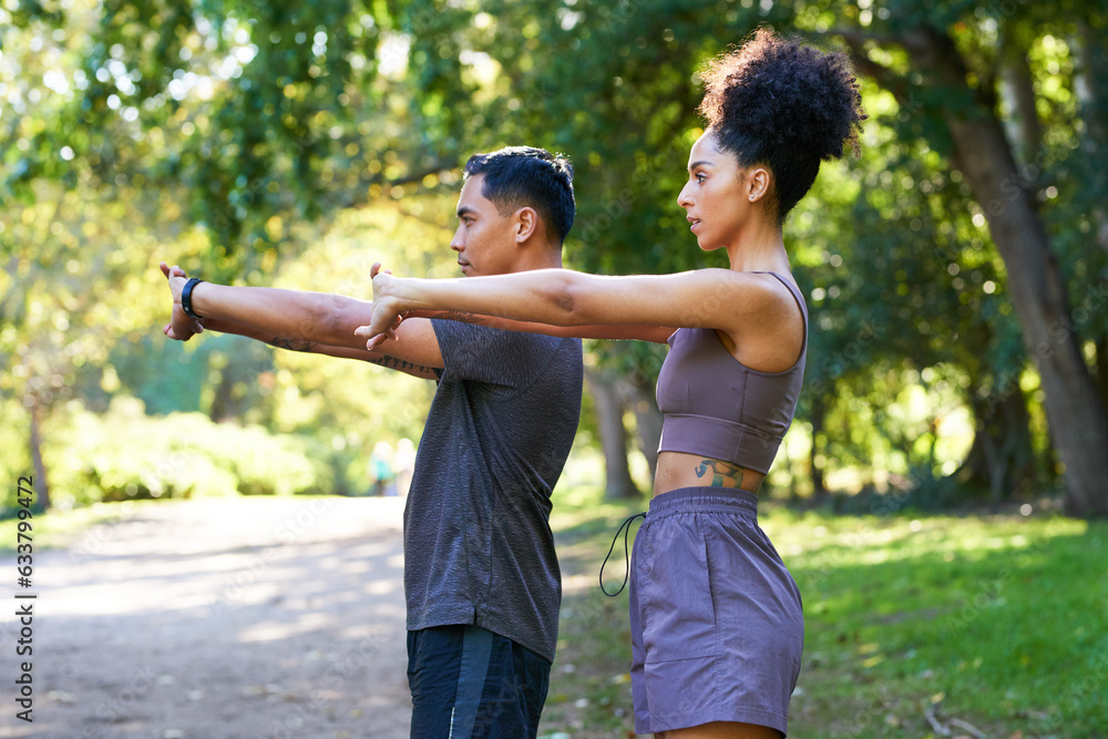 Beautiful couple stretch together before running in park, fitness trail run Beautiful couple stretch together before running in park, fitness trail run