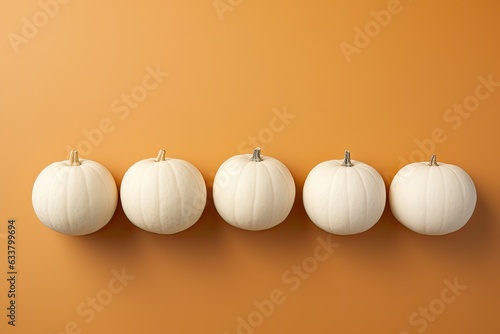 Five perfectly aligned white pumpkins