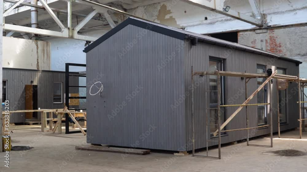 A new wooden modular prefabricated house inside an industrial building A new wooden modular prefabricated house inside an industrial building