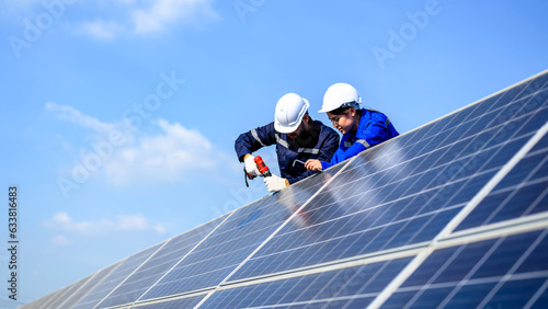 Technicians workers installing solar panels at solar cell farm