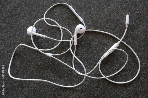 Close up of tangled earphones on table