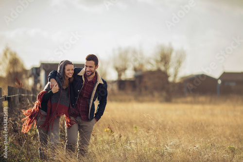 Young couple walking on a field in the countryside
