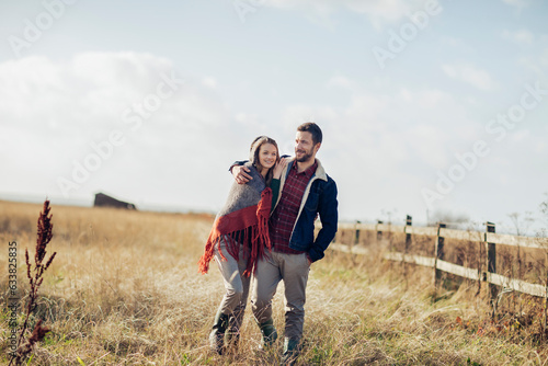 Young couple walking on a field in the countryside