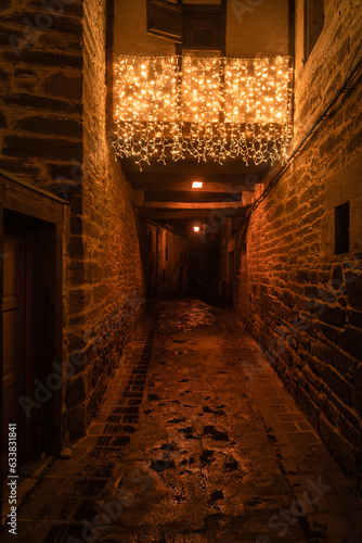 Beautiful street of the medieval village of Puebla de Sanabria, in Zamora, with the christmas illumination at night. Spain photo