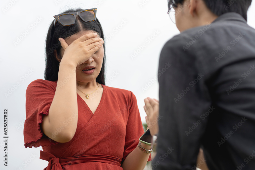 An emotional young woman breaks down and cries after feeling betrayed