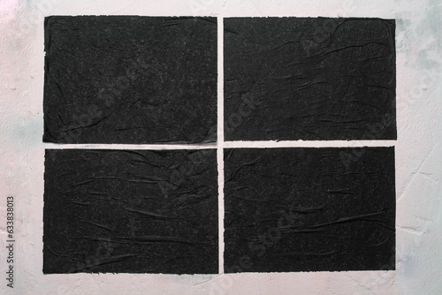 Four sheets of black paper with folds.