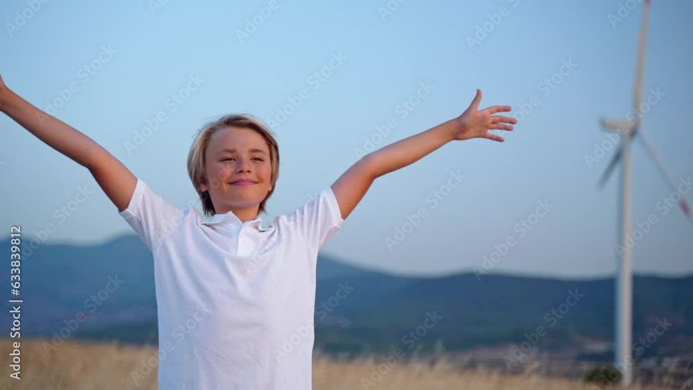 Relaxed teen boy breathing fresh air raising arms over blue sky sunset twilight at summer. Dreaming, freedom and traveling concept. Relaxed teen boy breathing fresh air raising arms over blue sky sunset twilight at summer. Dreaming, freedom and traveling concept.