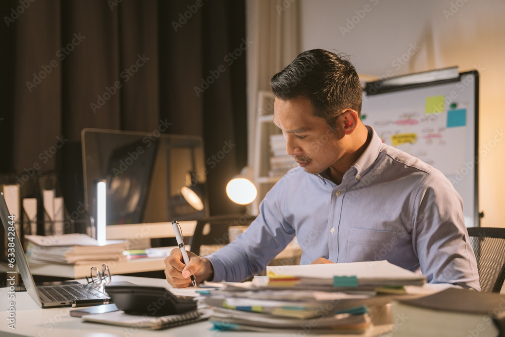 Young Asian businessman talking on the phone
late night hustle ambitious Working overtime talking on the phone in the organization Young Asian businessman talking on the phone
late night hustle ambitious Working overtime talking on the phone in the organization