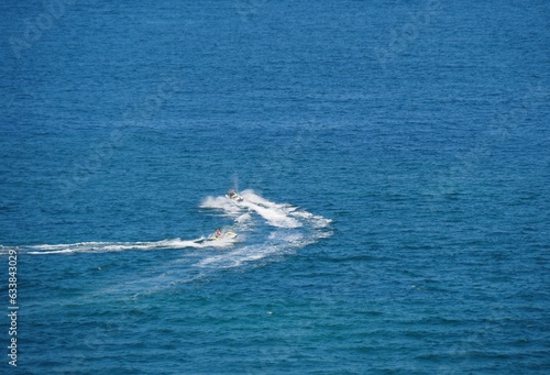 Jet ski crossing the wake of a powerboat off the coast of Miami, Florida. 