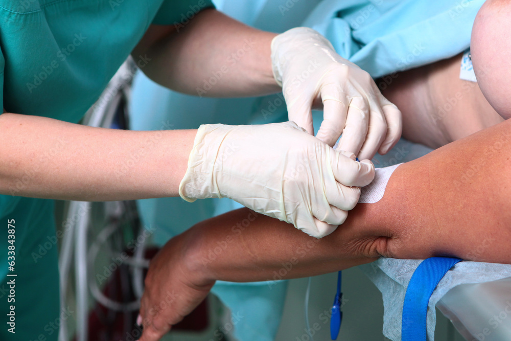 Anesthesiologist installs central venous catheter to patient before