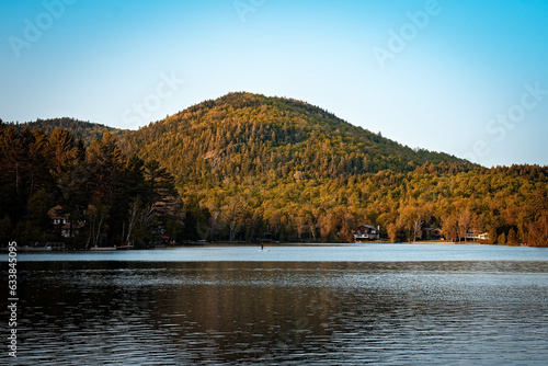 sunset in the mountains in a town lake with blue 