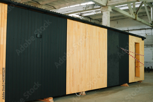 Newly built single storey prefabricated modular building. Prefabricated mobile wooden house at construction site