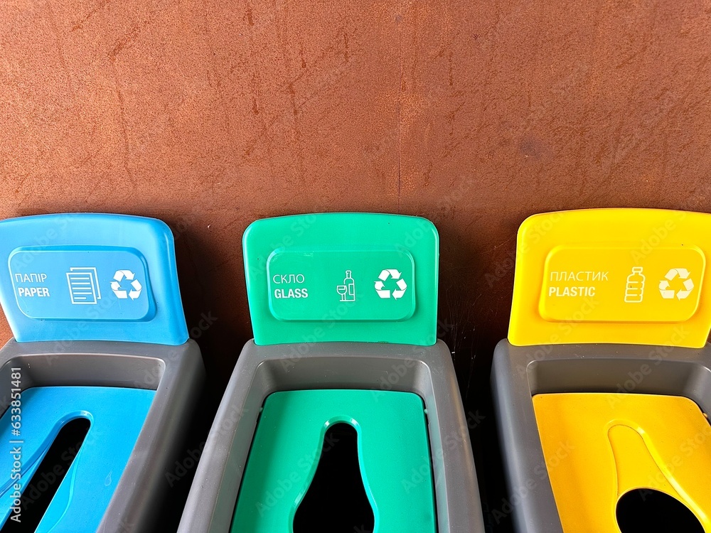 Multicolored plastic trash cans with the inscription paper, glass, plastic for sorting different