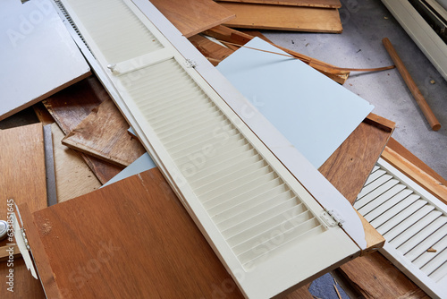 demolition byproducts, lumber, broken furniture and planks lying on the floor of a room