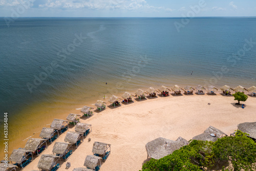 Aerial view of palm-thatched beach huts at Pindobal, a freshwater beach on the banks of the Tapajos river in Belterra, Para, Brazil. photo