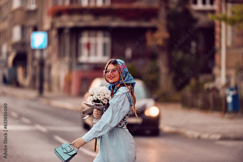 Charm of a woman adorned in an exquisite blue traditional dress, carrying a blue handbag and a bouquet of flowers, gracefully strolling through the city at sunset, creating a mesmerizing scene of Charm of a woman adorned in an exquisite blue traditional dress, carrying a blue handbag and a bouquet of flowers, gracefully strolling through the city at sunset, creating a mesmerizing scene of