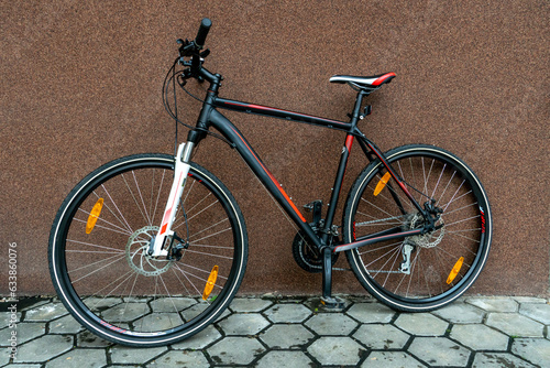 Details of a mountain bike close-up. Cycling for fun and health. Active leisure. A new bike is standing outside on a sunny summer day.