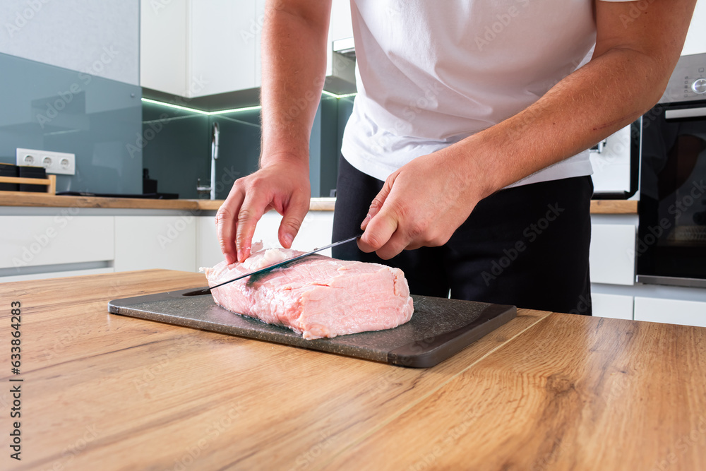 Preparing pork meat on the kitchen