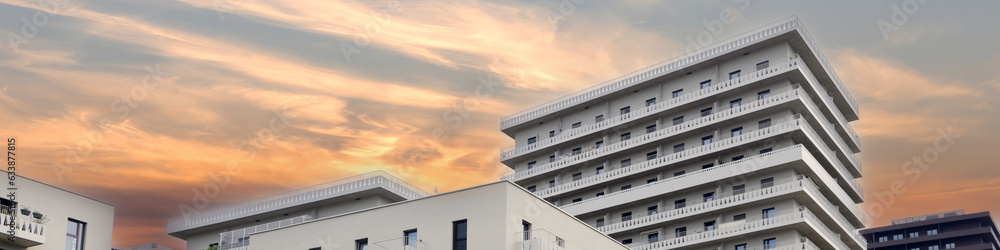 Banner modern houses against the background of the sunset sky Banner modern houses against the background of the sunset sky