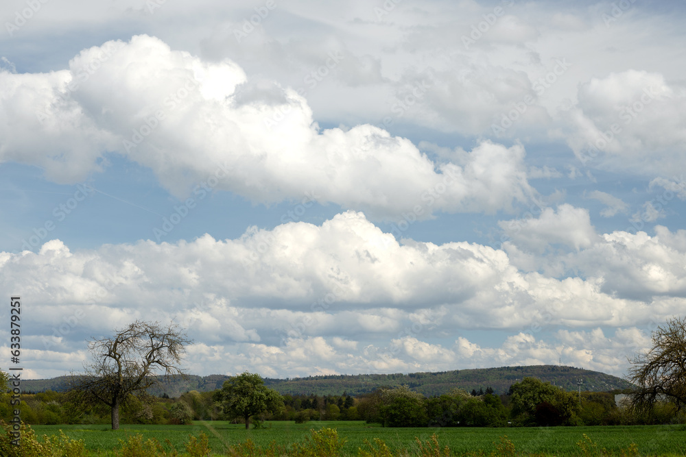 Cumulus beautiful clouds in blue sky, rural landscape Cumulus beautiful clouds in blue sky, rural landscape