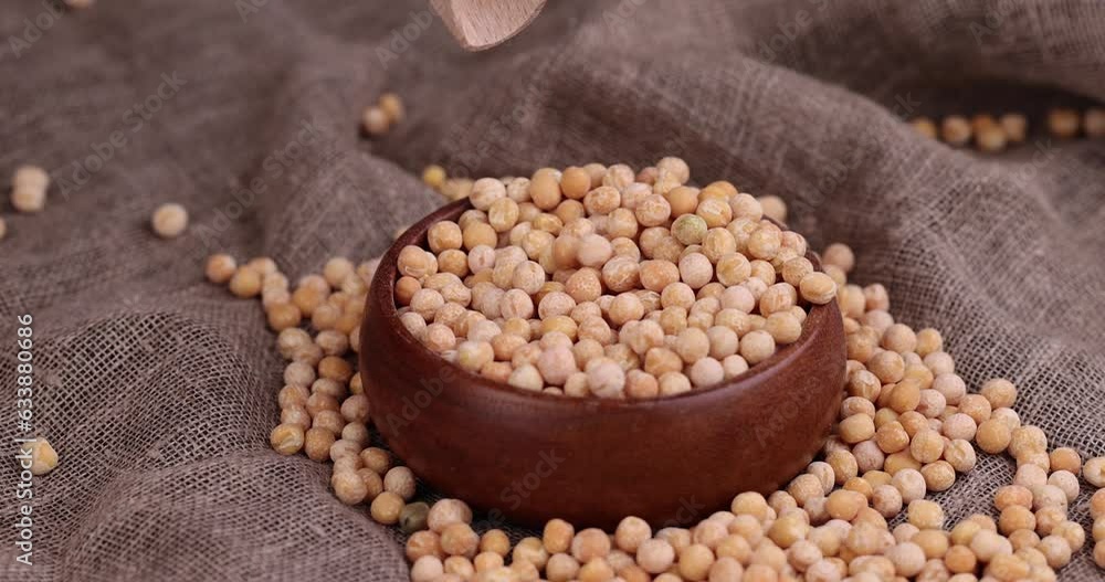 pour dry hard yellow peas for cooking porridge, dry yellow peas scattered before cooking pour dry hard yellow peas for cooking porridge, dry yellow peas scattered before cooking