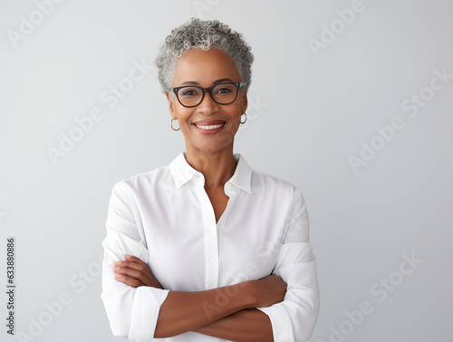 Portrait of a Smiling African American Business Woman middle age 50s 40s arms crossed isolated white background