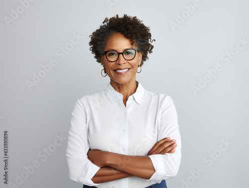 Portrait of a Smiling African American Business Woman middle age 50s 40s arms crossed isolated white background