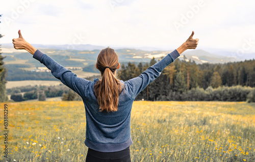 Happy Woman Standing in Tranquil Autumn Field with Outstretched Arms