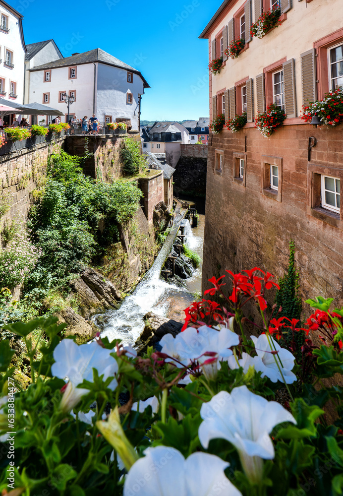 Waterfall in the city center of Saarburg, Germany surrounded by houses on a hill