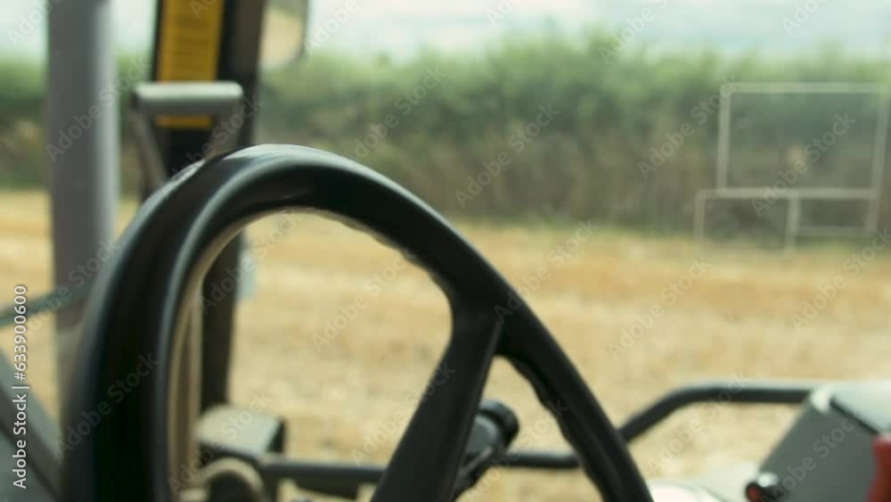 Close-Up of Hands on Tractor Steering Wheel During Wheat Harvest Close-Up of Hands on Tractor Steering Wheel During Wheat Harvest