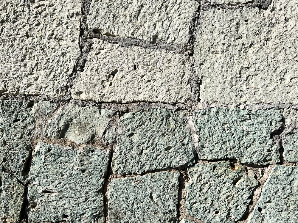 Naklejka premium Old wall made of green cantera stone in Oaxaca, Mexico