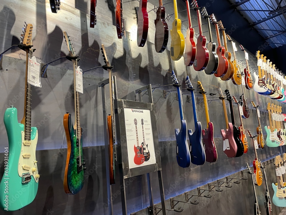 Guitar Center retail store interior wall of electric guitars Stock