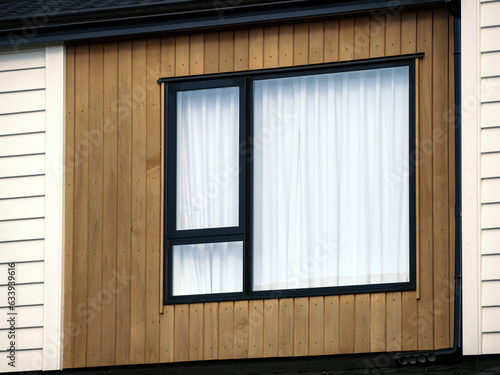 Wall Mural Typical window with modern metal frame on weatherboard wall.