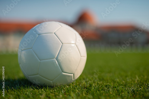 Soccer on grass and stadium. Ball on field. White soccer ball for mockup © Dexon Dee